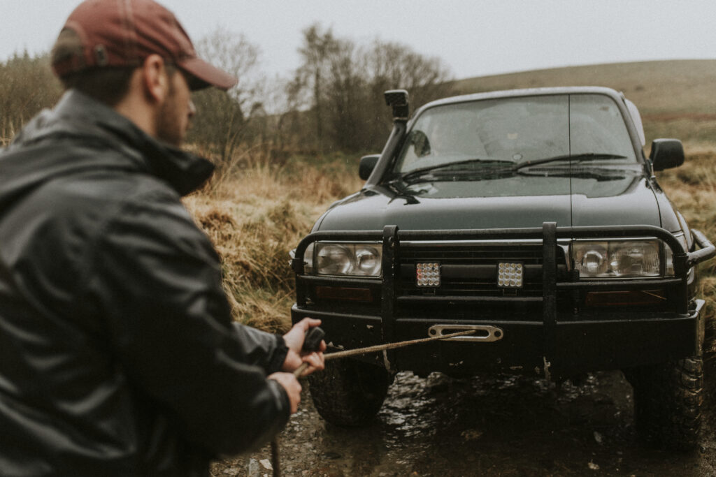 man pulling the car towing cable